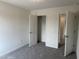 Spacious bedroom featuring plush carpeting and convenient closet access at 4012 Kingcraig Ln, Zebulon, NC 27597