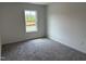 Well-lit bedroom with soft carpet and large window showcasing natural light at 4012 Kingcraig Ln, Zebulon, NC 27597