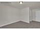 Cozy carpeted bedroom with neutral walls, a flush mount ceiling light, and a door to the hall at 4012 Kingcraig Ln, Zebulon, NC 27597