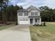 Charming two-story home featuring a two-car garage, stone accents, and a well-manicured lawn at 4012 Kingcraig Ln, Zebulon, NC 27597