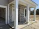 Charming front porch with stone accents and sturdy white pillars at 4012 Kingcraig Ln, Zebulon, NC 27597