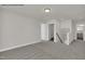 Upstairs hallway with carpet, showcasing access to other rooms and a staircase at 4012 Kingcraig Ln, Zebulon, NC 27597