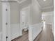 Hallway view of a full bathroom, featuring wood-look floors and paneled walls at 4012 Kingcraig Ln, Zebulon, NC 27597