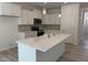 Bright kitchen with center island, stainless steel appliances, and sleek white cabinetry at 4012 Kingcraig Ln, Zebulon, NC 27597