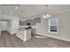 Modern kitchen with gray cabinets, stainless steel appliances, and a central island at 4012 Kingcraig Ln, Zebulon, NC 27597