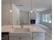 Bright kitchen with an island with sink, stainless steel appliances, and views into the living room at 4012 Kingcraig Ln, Zebulon, NC 27597