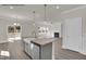 Open concept kitchen with granite island and stainless sink flows into the living area at 4012 Kingcraig Ln, Zebulon, NC 27597