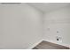 Utility room with hookups, wire rack, and durable wood-look floors at 4012 Kingcraig Ln, Zebulon, NC 27597