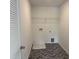 Bright laundry room includes storage and vinyl floors at 4012 Kingcraig Ln, Zebulon, NC 27597