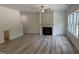 Bright and open living room featuring a modern fireplace, ceiling fan, and many windows at 4012 Kingcraig Ln, Zebulon, NC 27597