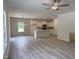 Open floorplan with kitchen, dining area, and living room with fireplace and plenty of natural light at 4012 Kingcraig Ln, Zebulon, NC 27597
