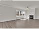 Open-concept living room with a fireplace and lots of natural light from the large windows at 4012 Kingcraig Ln, Zebulon, NC 27597