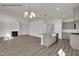 Spacious open-concept living area with a fireplace, kitchen and wood-look flooring at 4012 Kingcraig Ln, Zebulon, NC 27597