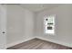 A modest room with light walls, one window, base trim, and hardwood floors at 4012 Kingcraig Ln, Zebulon, NC 27597
