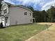 A side view of the exterior of the home with a freshly seeded and straw-covered side yard at 4012 Kingcraig Ln, Zebulon, NC 27597
