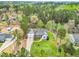 Aerial view of the home with beautiful landscaping, a long driveway, and mature trees at 402 Womble Dr, Lillington, NC 27546