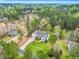 Aerial view of the home and neighborhood showcasing the wooded surroundings at 402 Womble Dr, Lillington, NC 27546