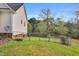 Fenced backyard with a grassy lawn with a green landscape and wooded view at 402 Womble Dr, Lillington, NC 27546