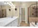 Bathroom featuring a double vanity with framed mirror and walk-in shower at 402 Womble Dr, Lillington, NC 27546