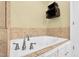 Relaxing soaking tub with tile surround and chrome faucet fixture at 402 Womble Dr, Lillington, NC 27546