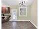 The dining area features tile flooring, a modern chandelier, and a view of the backyard at 402 Womble Dr, Lillington, NC 27546