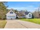Beautiful home with a spacious driveway, covered front porch, and lush lawn, offering a welcoming curb appeal at 402 Womble Dr, Lillington, NC 27546