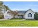 Inviting home with a cozy front porch, manicured lawn, and attached two-car garage, ideal for comfortable living at 402 Womble Dr, Lillington, NC 27546