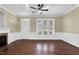 A bright living room showcases hardwood floors, neutral walls and trim, and a ceiling fan at 402 Womble Dr, Lillington, NC 27546
