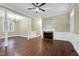 Bright living room featuring a fireplace, hardwood floors, and crown molding at 402 Womble Dr, Lillington, NC 27546