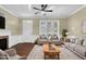 Bright living room featuring hardwood floors, neutral walls, and a ceiling fan at 402 Womble Dr, Lillington, NC 27546