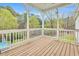 A view of the beautiful porch with a wood floor overlooking the peaceful backyard at 402 Womble Dr, Lillington, NC 27546