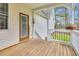 The wooden porch overlooks the lawn in the backyard at 402 Womble Dr, Lillington, NC 27546