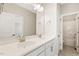 Bright bathroom features double sinks, white cabinets and a separate toilet room at 405 Daisy Grove Ln, Holly Springs, NC 27540