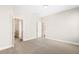 Neutral-toned bedroom featuring an ensuite bathroom, walk-in closet, and a carpeted floor at 405 Daisy Grove Ln, Holly Springs, NC 27540