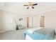 Large primary bedroom features tray ceilings, a ceiling fan, and access to a bathroom at 405 Daisy Grove Ln, Holly Springs, NC 27540