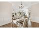 Open concept dining area with chandelier, with views to the kitchen and living room at 405 Daisy Grove Ln, Holly Springs, NC 27540