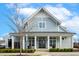 Charming building exterior with symmetrical design, landscaping, covered entrance, and double doors at 405 Daisy Grove Ln, Holly Springs, NC 27540