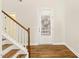 Bright foyer with hardwood floors, white walls, and a staircase, leading to the rest of the home at 405 Daisy Grove Ln, Holly Springs, NC 27540
