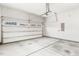 A well-lit garage with smooth concrete flooring and an automatic door opener at 405 Daisy Grove Ln, Holly Springs, NC 27540