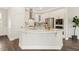 Open kitchen with a central island, stainless steel appliances, white cabinetry, and a gas cooktop for culinary enthusiasts at 405 Daisy Grove Ln, Holly Springs, NC 27540