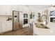 Beautiful kitchen featuring stainless steel appliances, a large island, and seamless flow into the living spaces at 405 Daisy Grove Ln, Holly Springs, NC 27540