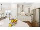 Modern kitchen featuring white cabinetry, stainless steel appliances, and a spacious island, seamlessly blending style and functionality at 405 Daisy Grove Ln, Holly Springs, NC 27540