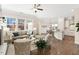 Open-concept living room flowing into the kitchen and dining areas, with hardwood floors and modern decor at 405 Daisy Grove Ln, Holly Springs, NC 27540