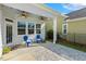 Inviting outdoor patio with seating, ceiling fans, and well-maintained landscaping at 405 Daisy Grove Ln, Holly Springs, NC 27540