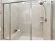 Updated tile shower with built-in bench and a glass enclosure at 405 Daisy Grove Ln, Holly Springs, NC 27540