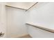 A walk-in closet with ample storage with wood shelving and carpet flooring at 405 Daisy Grove Ln, Holly Springs, NC 27540