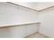 Walk-in closet featuring wood shelving and carpet flooring at 405 Daisy Grove Ln, Holly Springs, NC 27540