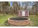 View of backyard featuring a shed and brick fire pit, perfect for outdoor entertaining at 4509 Alamance Baptist Church Loop, Burlington, NC 27215