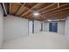 Unfinished basement featuring cement block walls, painted floor, and doorway at 4509 Alamance Baptist Church Loop, Burlington, NC 27215