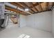 Unfinished basement featuring exposed wooden beams, cement block walls, and painted floor at 4509 Alamance Baptist Church Loop, Burlington, NC 27215